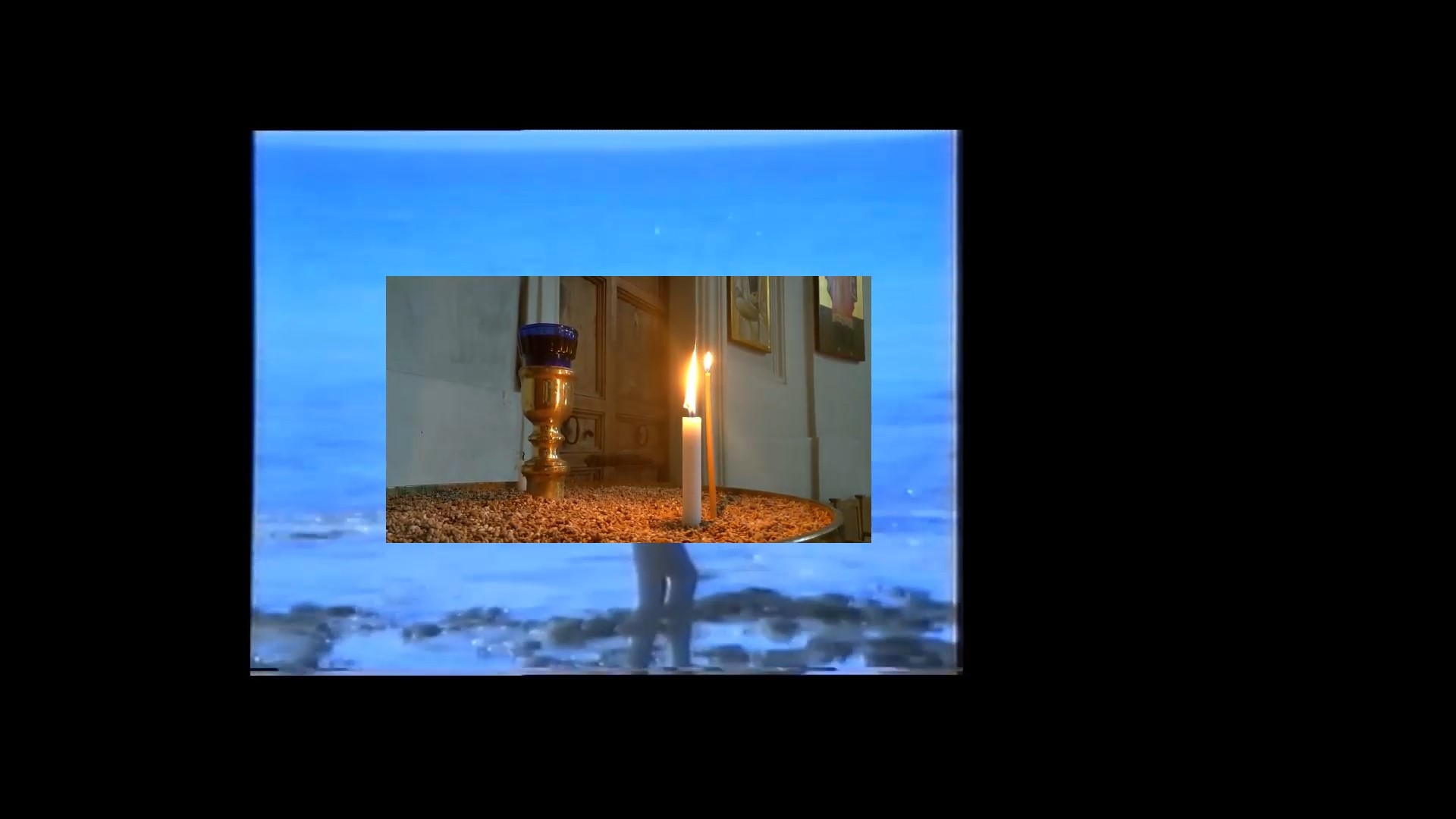 lit candles in a shrine superimposed on an image of a figure walking along a darkened shoreline