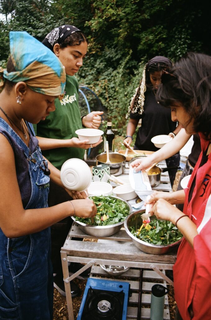 a group of four making salad around a table